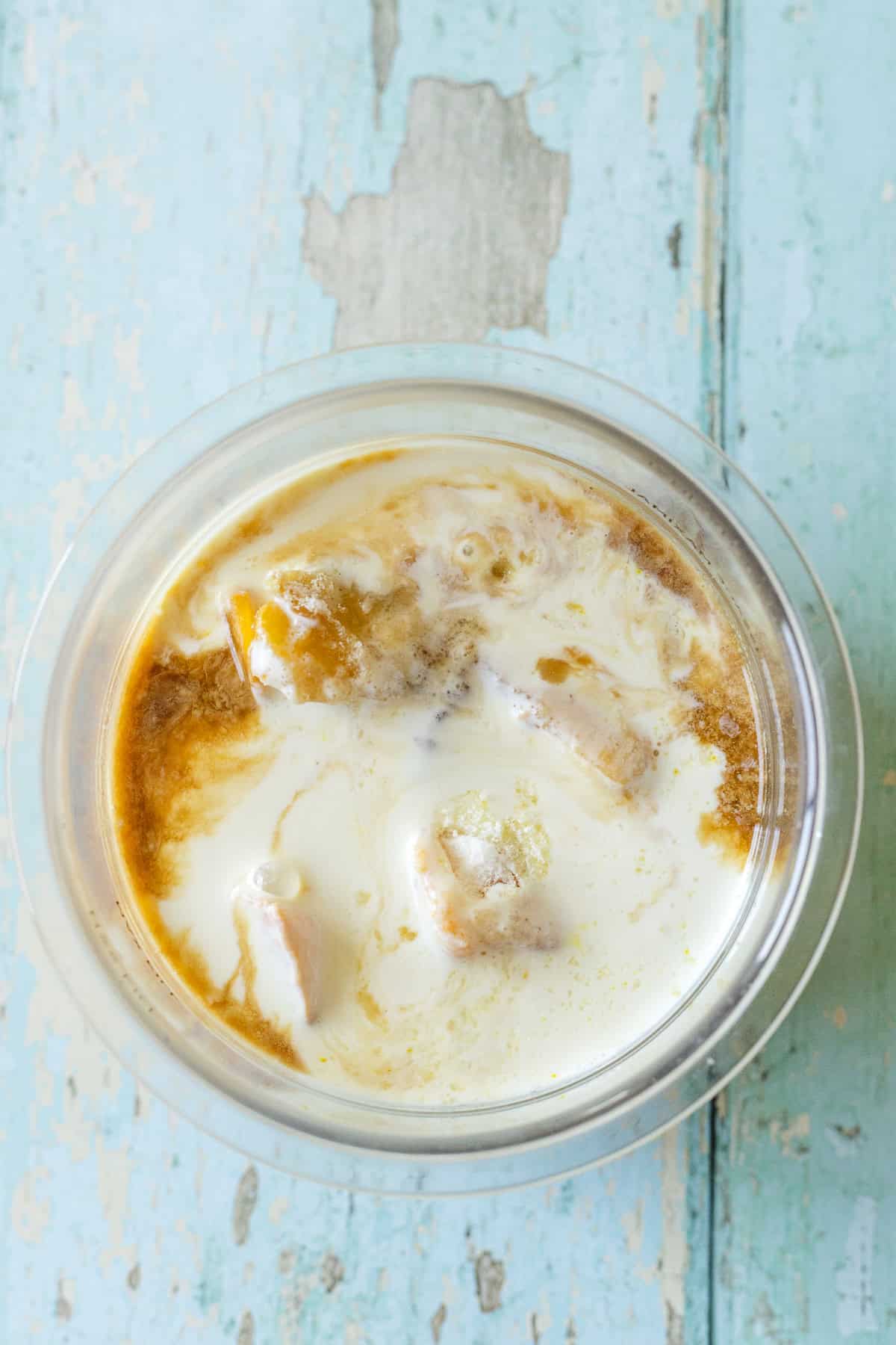 ninja creami pint with peach ice cream mixture before freezing.