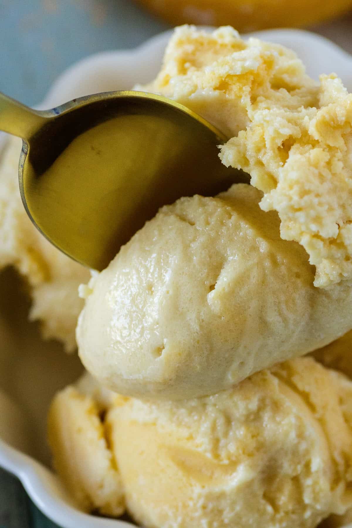 Creami peach ice cream served with a spoon, creamy and refreshing dessert.